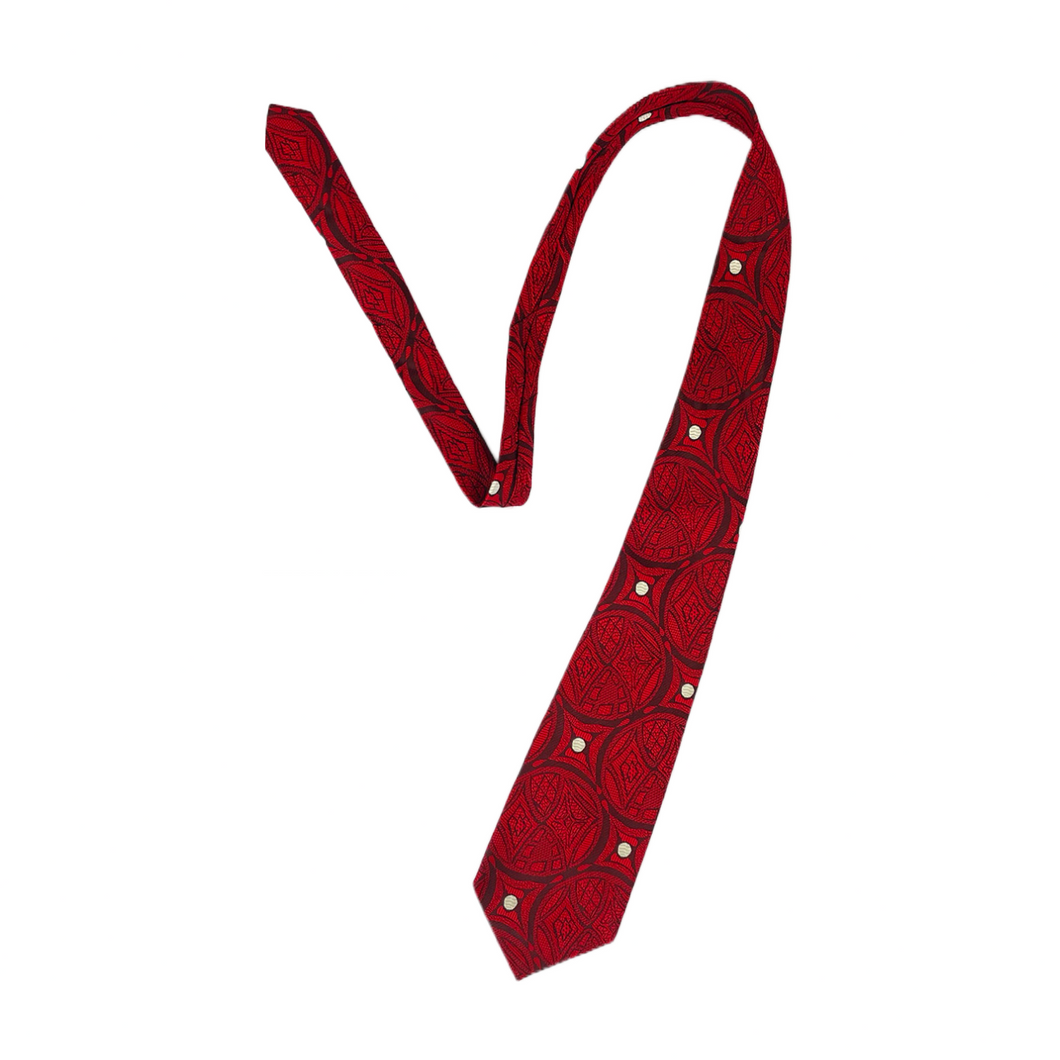 Standard sized red tie with a goth-y, tribal pattern all throughout.